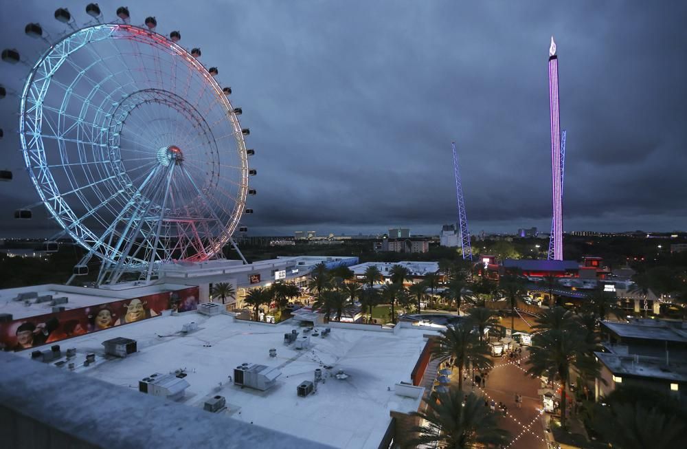 ICON Park attractions, The Wheel, left, Orlando SlingShot, middle, and Orlando FreeFall, right, are shown in Orlando, Fla., on Thursday, March 24, 2022.