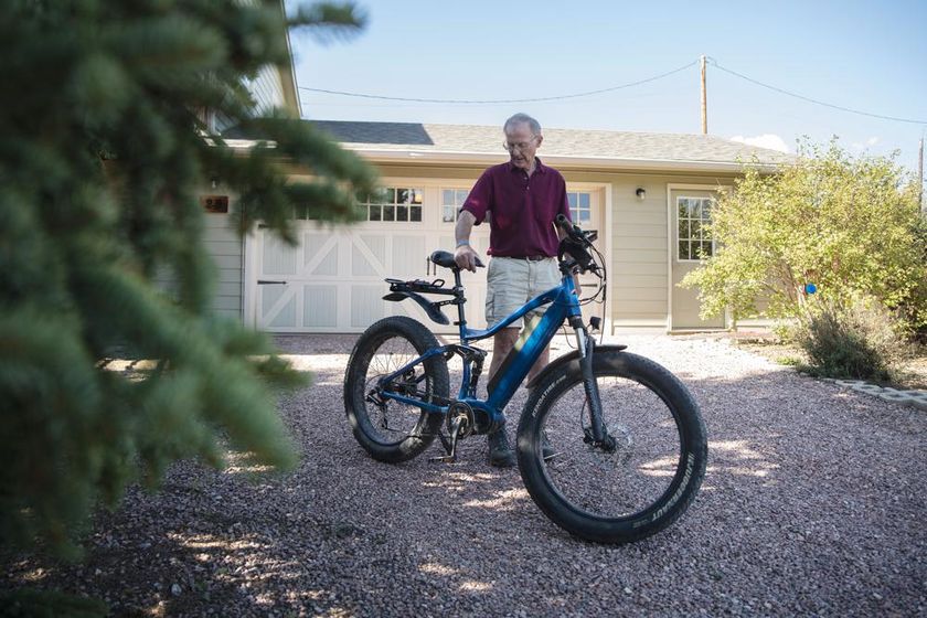 Kent Drummond, 80, prepares to ride his e-bike from his home in Divide, Colo., on Wednesday, Aug. 10, 2022
