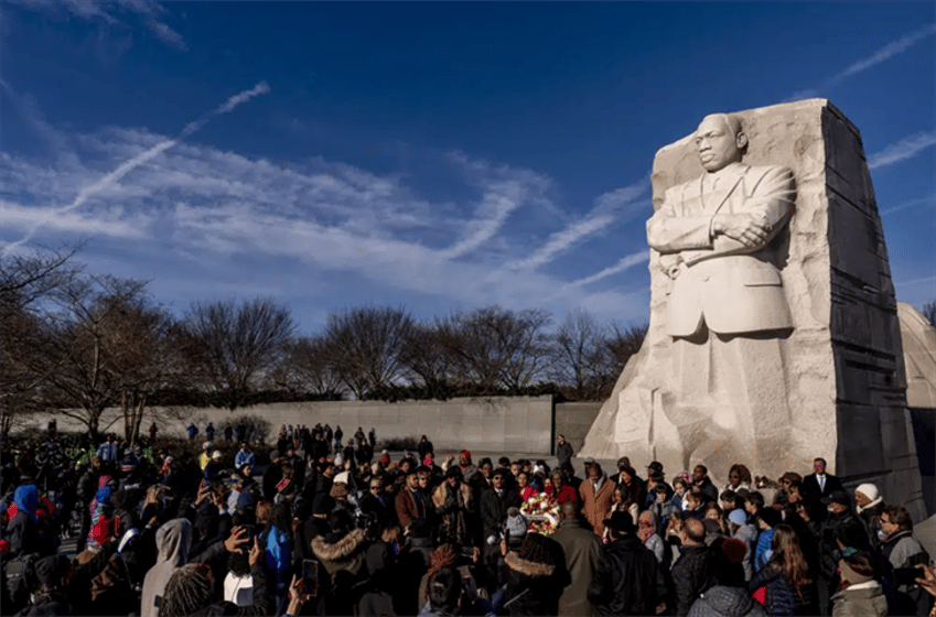 A large group gathers to watch a wreath-laying ceremony at the Martin Luther King Jr. Memorial on Martin Luther King Jr. Day in Washington, Monday, Jan. 16, 2023.