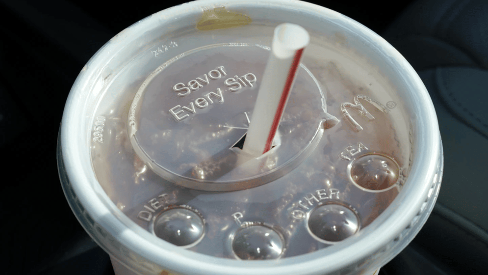A McDonald's beverage sits in a cup holder, April 27, 2021, Des Moines, Iowa. McDonald's plans to eliminate self-service soda machines at all of its U.S. restaurants by 2032, the Chicago-based fast food chain has confirmed.