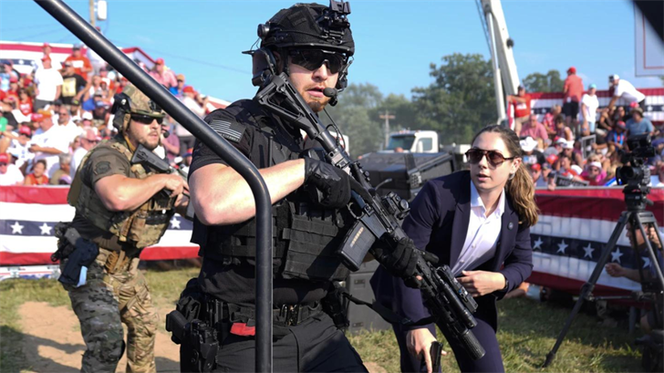 U.S. Secret Service agents respond as Republican presidential candidate former President Donald Trump is surrounded on stage by U.S. Secret Service agents at a campaign rally, July 13, 2024, in Butler, Pa.