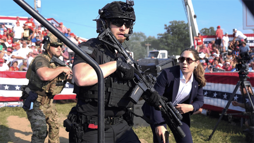 U.S. Secret Service agents respond as Republican presidential candidate former President Donald Trump is surrounded on stage by U.S. Secret Service agents at a campaign rally, July 13, 2024, in Butler, Pa.