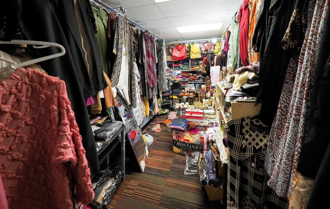 Fadumo Ibad sells clothing items in her shop located on Dakota Avenue in South Sioux City. The space she rents is one of many Somali-owned businesses on this block.
