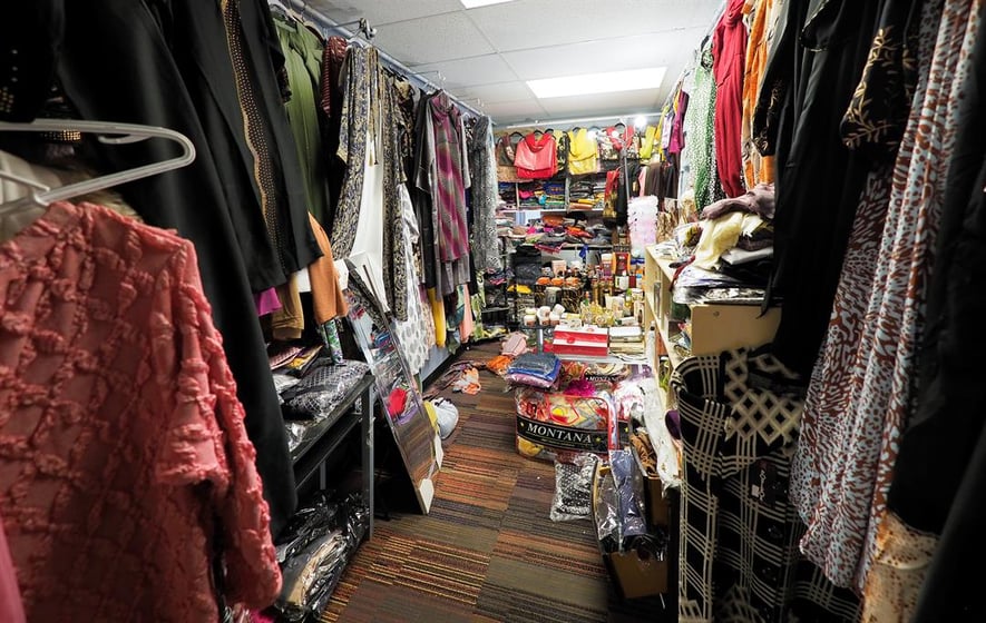 Fadumo Ibad sells clothing items in her shop located on Dakota Avenue in South Sioux City. The space she rents is one of many Somali-owned businesses on this block.