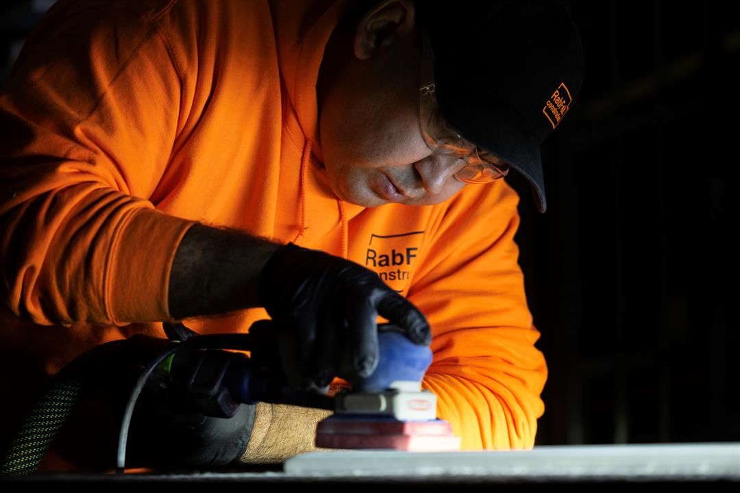 Freddy Hafiz sands a cabinet door in the shop at RabFak Construction on Friday, Jan. 17, 2025, in Omaha.