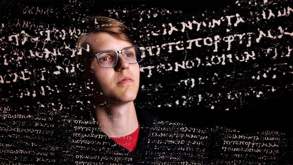 Luke Farritor with superimposed Greek text from a nearly 2,000-year-old scroll that his work helped decipher through the Vesuvius Challenge. Winning the challenge catapulted his career forward, ultimately pairing him with Elon Musk.
