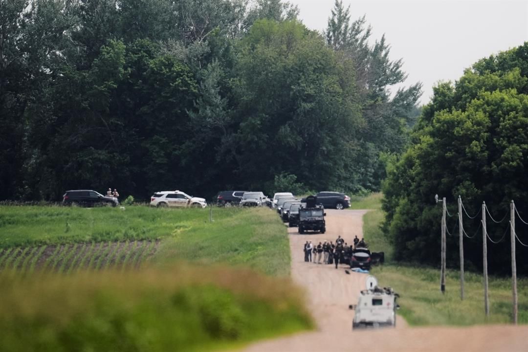 Members of law enforcement agencies investigate near a vehicle suspected to belong to shooting suspect, Vance Boelter, Sunday, June 15, 2025, in Belle Plaine, Minn. (AP Photo/George Walker IV)