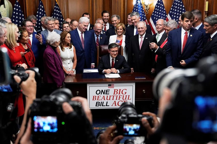 Speaker of the House Mike Johnson, R-La., surrounded by Republican members of Congress, signs President Donald Trump's signature bill of tax breaks and spending cuts, Thursday, July 3, 2025, at the Capitol in Washington. (AP Photo/Julia Demaree Nikhinson)