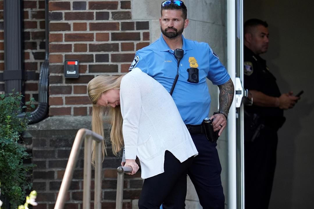 A person walks out of the Annunciation Church's school as police respond to a reported mass shooting, Wednesday, Aug. 27, 2025, in Minneapolis. (AP Photo/Abbie Parr)