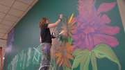 Artist painting mural in Norfolk as part of national project